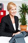 Middle aged woman working at desk