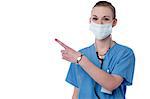 Female physician with surgical mask and pointing away
