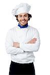 Smiling male chef in white uniform with crossed arms