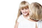 Mother kissing her daughter while daughter posing to the camera