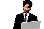 Young indian businessman working with laptop