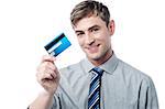 Handsome young executive holding credit card