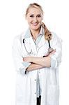 Smiling female doctor posing with folded arms