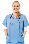 Female doctor with stethoscope and hands in pocket