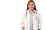 Smiling female doctor with hands on coat pockets