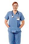 Female doctor with stethoscope and hands in pocket