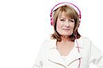 Mature smiling woman listening music with headphones