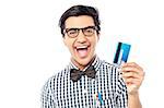 Young cheerful man showing his credit card to camera