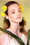 cuacasian woman wearing yellow flowers on green background