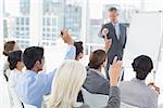 Business people raising their arms during meeting in office