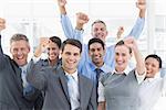 Smiling business people cheering in office
