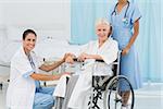 doctors and patient in wheelchair at the hospital