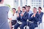 Business people applauding during meeting in office