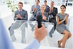 Business team applauding during conference in meeting room