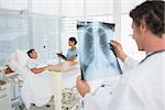 Doctor checking patients xray in hospital room