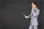 Businessman on the phone against grey background