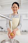 Woman washing potatoes