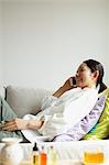 Woman using a Smartphone on the sofa