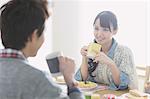 Young adult couple having breakfast in their dining room