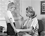 1970s MOTHER DISCIPLINING HER SON BY TALKING HARSHLY AND SHAKING HER FINGER BOY HANGING HIS HEAD IN SHAME