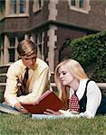 1960s MAN AND WOMAN READING OUTDOOR