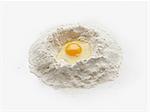 Baking preparation with raw egg in center of flour stack