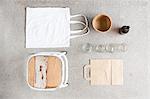 Overhead still life of stool, reusable shopping bag and recyclable paper and bottles