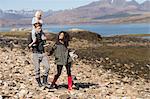 Family on walk, man carrying son on shoulders, Loch Eishort, Isle of Skye, Hebrides, Scotland