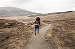 Woman hiking on path, Fairy Pools, Isle of Skye, Hebrides, Scotland