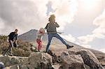 Family walking over boulders, Fair Pools, Isle of Skye, Hebrides, Scotland