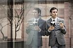 Mature businessman, eating lunch from takeaway box, outdoors