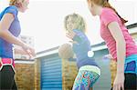 Portrait of three women exercising together playing basketball