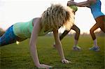 Portrait of woman doing push up exercise in park