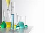 Laboratory glassware on lab bench with a graduated measuring cylinder in foreground