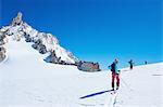 Three mature adult skiers moving up Mont Blanc massif, Graian Alps, France