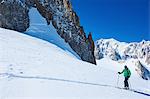 Mature male skier moving up Mont Blanc massif, Graian Alps, France