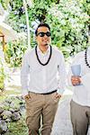 Bridegroom preparing for Hawaiian wedding wearing kukui nut beads, Kaaawa, Oahu, Hawaii, USA