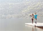 Young couple strolling on pier at Lake Mergozzo, Verbania, Piemonte, Italy