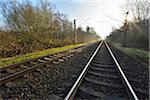 Railroad tracks with Sun, Arheiligen, Darmstadt, Hesse, Germany