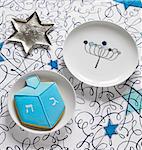 A start-shaped sliver dish, a plate and a a biscuit for Hanukkah