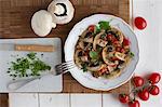 Fried mushrooms with tomatoes and parsley