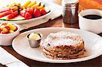 Blueberry pancakes with icing sugar, coffee and fruit
