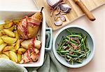 Bacon-wrapped pears with roast potatoes and a bean and onion salad