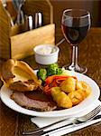 Roast beef with sides and red wine