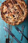 An apple pie and old cutlery (seen from above)