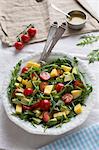 Mango and avocado salad with cherry tomatoes and rocket