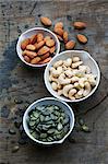 Bowls of almonds, cashew nuts and pumpkin seeds