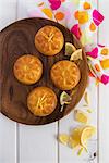 Mini lemon cakes on a wooden plate
