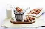 Cantucci in a wire basket and on a chopping board