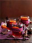 Glasses of mulled wine with cinnamon, anise and orange slices